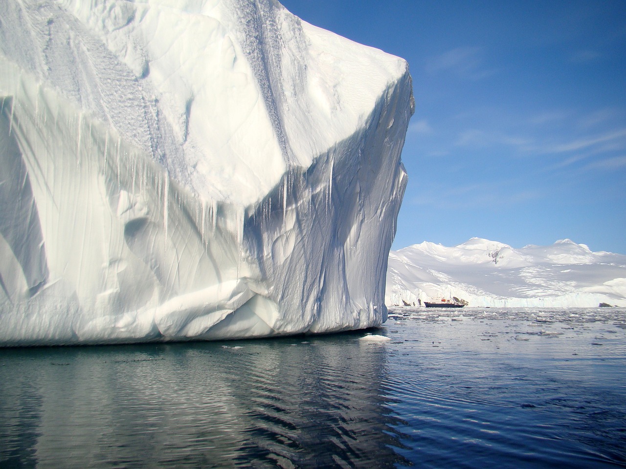 Generic ice-strengthened expedition ship navigating a narrow channel between Arctic glaciers